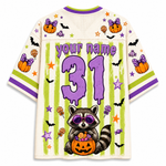 A Halloween-themed short-sleeve jersey shirt shown from the back, featuring a cream mesh base with purple and lime green graphics. The design includes the text 'your name', the number '31' in purple, a raccoon holding a jack-o'-lantern, bats, pumpkins, stars, and candy motifs.