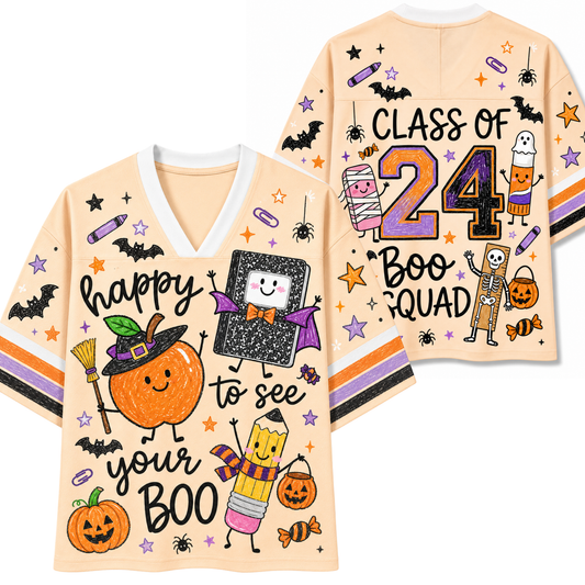 A peach-colored V-neck t-shirt with Halloween-themed graphics, shown in both front and back views. The front features 'happy to see your BOO' with a smiling pumpkin, witch hat, book, pencil, and candy.