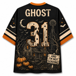A black short-sleeve jersey shown from the back, featuring a distressed Halloween graphic with the name GHOST, number 31, a haunted house, pumpkins, bats, a moon, and a sign reading AND I'M NOT LEAVING. The collar and sleeve cuffs are orange.