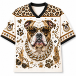 A short-sleeve V-neck t-shirt featuring a large graphic of an English Bulldog wearing leopard-print sunglasses and a gold chain necklace. The shirt has a cream-colored body, leopard-print patterns on the shoulders and sleeves, and black trim on the collar and sleeve cuffs.