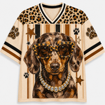 Front view of the cream varsity jersey displaying a swag Dachshund wearing leopard-frame sunglasses, a sparkling diamond necklace, and vertical stripes.