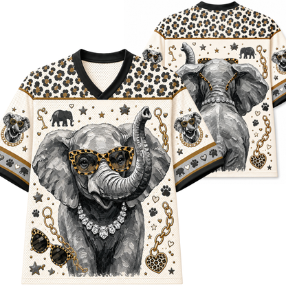 A V-neck short-sleeve shirt shown from the front and back, featuring a large illustrated elephant wearing leopard-print sunglasses, a diamond necklace, and a raised trunk on an off-white background with leopard-print shoulder panels and small decorative motifs.