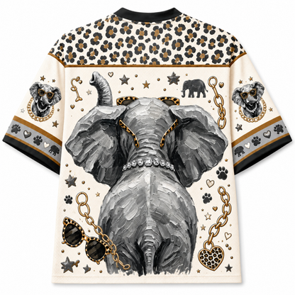 A short-sleeve crewneck t-shirt featuring a detailed graphic print of an elephant's rear, decorated with gold chains, sunglasses, paw prints, and leopard print patterns on the shoulders and sleeves.