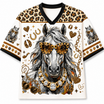 A short-sleeve V-neck t-shirt featuring a detailed graphic of a gray horse wearing leopard-print sunglasses and a jeweled necklace, surrounded by gold chains, hearts, stars, and paw prints. The shirt has leopard-print shoulder panels and cuffs with black trim.