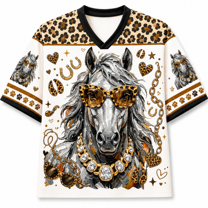 A short-sleeve V-neck t-shirt featuring a detailed graphic of a gray horse wearing leopard-print sunglasses and a jeweled necklace, surrounded by gold chains, hearts, stars, and paw prints. The shirt has leopard-print shoulder panels and cuffs with black trim.