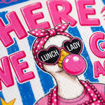 Close-up of a colorful printed graphic featuring a cartoon duck wearing pink polka-dot sunglasses with the words 'LUNCH LADY' on the lenses, a pink polka-dot bow headband, and a pink bubblegum bubble against blue-and-white striped lettering.