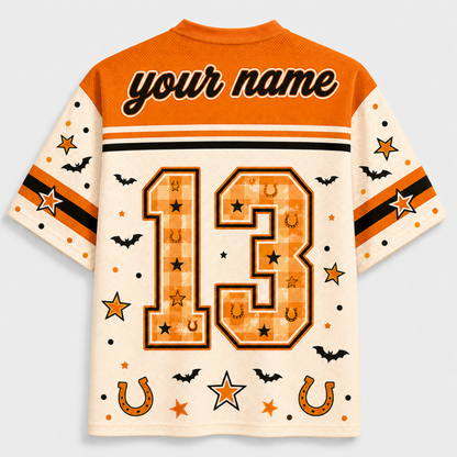 Custom short-sleeve athletic jersey shown from the back, featuring an orange yoke, cream sleeves, and a large orange number 13 with stars, horseshoes, and bats. The top has placeholder text reading 'your name'.