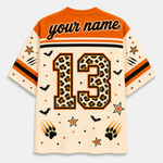 Customizable Halloween-themed short-sleeve jersey shown from the back, featuring a leopard-print number 13, bat silhouettes, paw prints, stars, and 'your name' text on an orange and cream mesh fabric.