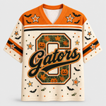 A short-sleeve football-style jersey with a Halloween theme, featuring an orange collar and shoulders, cream body, and a large 'G' on the front decorated with pumpkins, maple leaves, and bats.