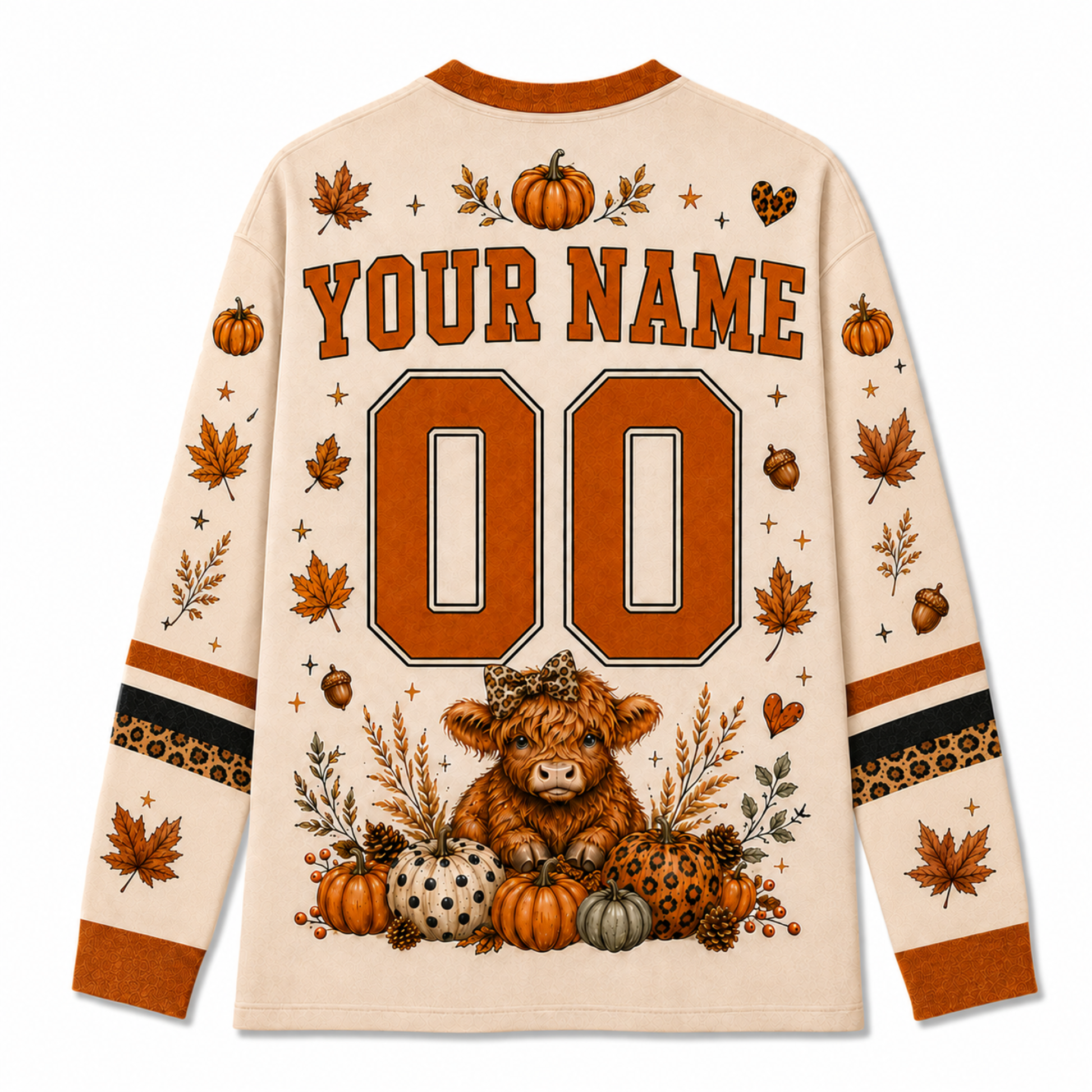 A long-sleeve cream-colored shirt shown from the back, featuring a customizable design with 'YOUR NAME' and '00' in orange varsity-style lettering. The design includes autumn-themed illustrations such as pumpkins, acorns, leaves, and a small Highland cow on a white background.