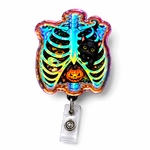 A Halloween-themed retractable badge reel featuring a colorful, iridescent rib cage design with a black cat and jack-o'-lantern, attached to a clear plastic reel on a white background.