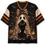 A black short-sleeve V-neck jersey-style shirt with a large Halloween graphic of a black cat under a leopard-print bow and spiderweb cloak, plus pumpkins, bats, stars, and a lantern. The sleeves have beige mesh panels with black and orange stripes.