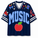 Front view of the navy blue varsity jersey displaying 'MUSIC' in blue gingham pattern above a red stitched apple and school supply doodles.