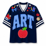 Front view of the navy blue varsity jersey displaying 'ART' in blue gingham pattern above a red stitched apple and school supply doodles.