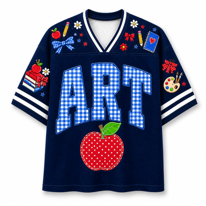 Front view of the navy blue varsity jersey displaying 'ART' in blue gingham pattern above a red stitched apple and school supply doodles.
