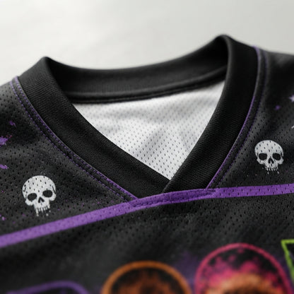 Close-up of a black athletic jersey with a purple V-neck trim, white skull graphics on the shoulders, and a purple horizontal stripe across the chest.