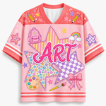 Front view of the yellow varsity jersey displaying 'Art' typography over checkerboard stars surrounded by rainbows, pencils, and coquette ribbon bows.