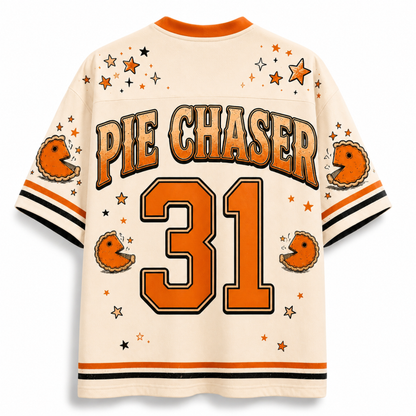 Back view of a cream-colored Pie Chaser 31 jersey with orange and black accents, featuring a retro football theme with stars, stripes, and Pac-Man graphics.