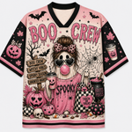 A short-sleeve V-neck t-shirt with a pink and black Halloween theme, featuring a cartoon witch character, pumpkins, skulls, spiderwebs, and the text 'BOO CREW' and 'Spooky'.