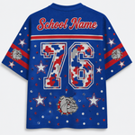 A royal blue short-sleeve t-shirt shown from the back, featuring a customizable 'School Name' text at the collar, a large number '76' filled with a red, white, and blue camouflage pattern, and a bulldog mascot graphic near the bottom. The sleeves have red and white stripes with bulldog head graphics, and the entire shirt is decorated with white stars and silver glitter dots.