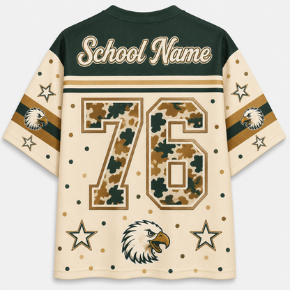 Customizable short-sleeve athletic jersey shown from the back, featuring a dark green collar and shoulders, cream body, camouflage patterned number 76, gold and dark green stripes on the sleeves, eagle head graphics, and 'School Name' text at the top.