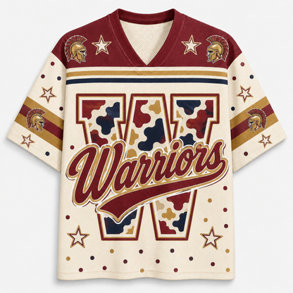 A short-sleeve V-neck jersey-style shirt with a cream base, burgundy shoulder panels, gold and navy stripes, star motifs, and a large camouflage-style letter W with the word Warriors across the front.