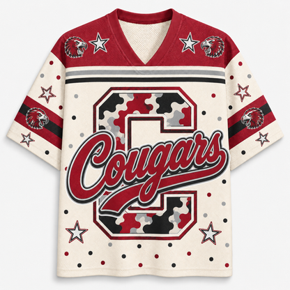 A short-sleeve V-neck athletic jersey with a cream base, red shoulders, and a large camouflage-style letter C with the word 'Cougars' across the front. The sleeves have red and black stripes, white stars, and cougar head logos.