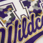 Close-up of a purple and white athletic jersey with gold and gray camouflage lettering and mesh texture.