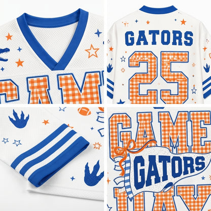 A white football-style jersey shown in multiple views, featuring blue trim and lettering, orange gingham lettering and numbers, and small blue and orange star/fish motifs. The front shows a V-neck and part of the word 'RAM'; the back shows 'GATORS' and the number '25'; one panel shows sleeve stripes and another shows the back collar area.