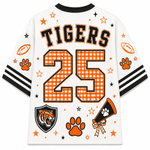 White short-sleeve football jersey shown from the back, featuring 'TIGERS' and the number '25' in orange gingham with black outlines. The design includes orange paw prints, stars, footballs, a tiger head shield, and a megaphone graphic, with black and white striped sleeve accents.
