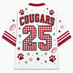 White athletic-style jersey shown from the back with red trim, the word COUGARS across the shoulders, the number 25 in red-and-white gingham, and scattered paw prints, stars, and football motifs on a light gray background.