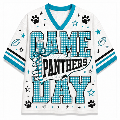 A white short-sleeve V-neck jersey-style shirt with turquoise and black sports graphics. The front reads “GAME PANTHERS DAY” in large gingham block letters, with paw prints, stars, footballs, and striped sleeve accents.