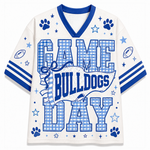 A white mesh football-style jersey with royal blue trim and graphics, featuring the words “GAME BULLDOGS DAY” in large blue-and-white gingham block letters, with paw prints, stars, footballs, and stripes on the sleeves.