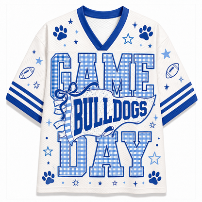 A white mesh football-style jersey with royal blue trim and graphics, featuring the words “GAME BULLDOGS DAY” in large blue-and-white gingham block letters, with paw prints, stars, footballs, and stripes on the sleeves.