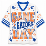 A white mesh short-sleeve V-neck jersey with blue trim and orange/blue 'GAME GATORS DAY' text, decorated with gingham letters, blue gators, footballs, stars, and stripes.