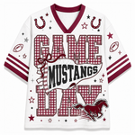A white mesh football-style jersey with maroon trim and a large 'GAME MUSTANGS DAY' graphic on the front. The design includes horseshoes, stars, footballs, stripes on the sleeves, and a running mustang illustration.