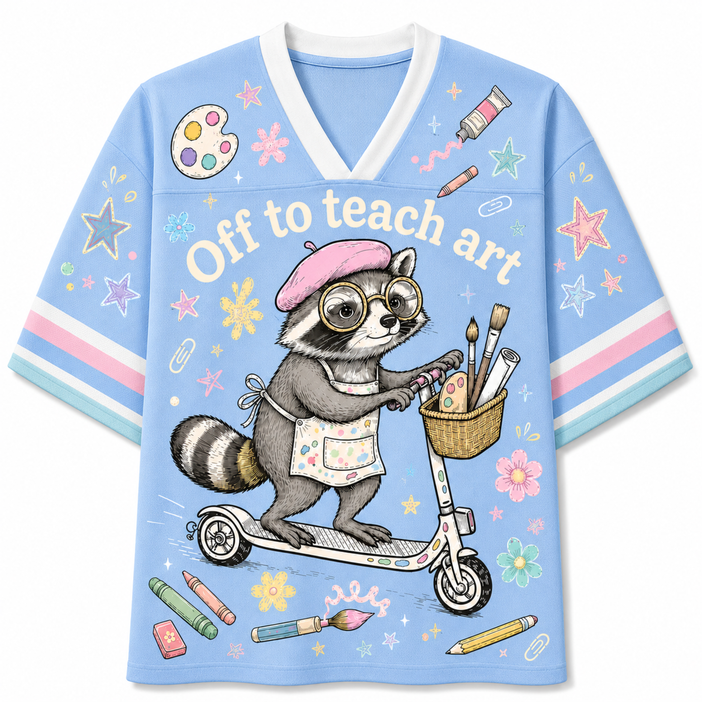 A light blue V-neck graphic T-shirt featuring a cartoon raccoon wearing glasses and a pink beret, riding a scooter with paintbrushes in a basket. The shirt includes the text 'Off to teach art' and is decorated with colorful paintbrushes, stars, and flowers on a white background.