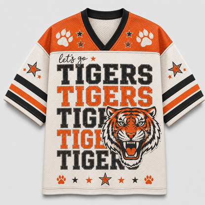 A short-sleeve V-neck football jersey with a tiger-themed graphic. The jersey features orange shoulder panels, a cream mesh body, black and orange sleeve stripes, paw prints, stars, and the text 'let's go TIGERS TIGERS TIGERS TIGER' alongside a roaring tiger head illustration.