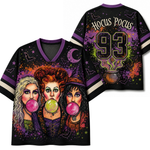 A black V-neck t-shirt with purple trim, featuring a colorful graphic of the three witches from The Addams Family blowing pink bubblegum bubbles. The back of the shirt features 'Hocus Pocus' in stylized text, the number '93' with a cauldron graphic, and purple, green, and orange splatter details.