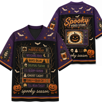 A purple short-sleeve V-neck T-shirt shown from both front and back, featuring a Halloween-themed graphic print with pumpkins, bats, spiderwebs, book spines, ghosts, and the text 'Spooky Video Store' and 'spooky season'.