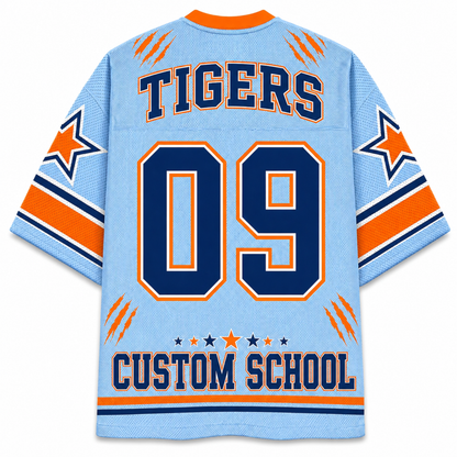 A light blue mesh sports jersey shown from the back, featuring navy and orange graphics. The back displays 'TIGERS' and the number '09' in large navy varsity-style lettering with orange borders, along with 'CUSTOM SCHOOL' at the bottom.