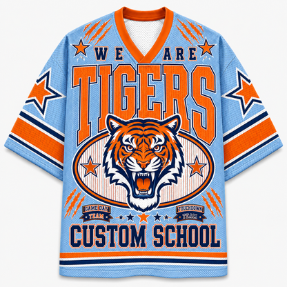 A light blue short-sleeve V-neck jersey with orange and navy graphics, featuring a tiger head illustration and the text 'WE ARE TIGERS' and 'CUSTOM SCHOOL'.