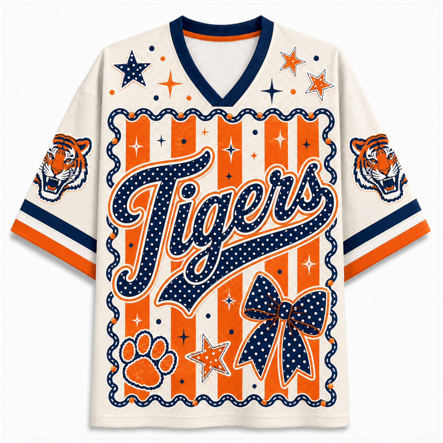 A short-sleeve V-neck jersey-style shirt with a tiger-themed graphic. The main body is off-white, with bold orange and navy blue graphics including the word 'Tigers' in script, stars, paw print, bow, stripes, and tiger head illustrations on the sleeves.