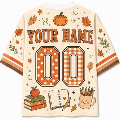 Back view of the Chaotic Club jersey showcasing 'YOUR NAME' typography above a polka dot and gingham pattern athletic number 00 surrounded by pumpkin and notebook doodles.