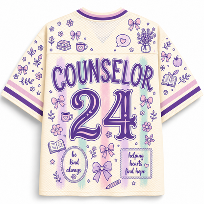 A cream-colored short-sleeve athletic jersey with purple and pastel watercolor accents, featuring the word 'COUNSELOR' and the number '24' on the back, surrounded by cute illustrations like bows, flowers, books, and hearts.