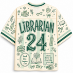 A cream-colored short-sleeve t-shirt with green and light green graphics on the back, featuring the text 'LIBRARIAN 24' surrounded by illustrations of books, glasses, bows, and a coffee cup.
