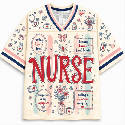 A cream-colored short-sleeve V-neck jersey-style top with navy and pink trim, decorated with medical-themed illustrations and the word 'NURSE' in large red letters across the front.