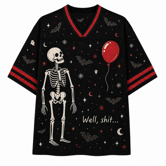 A black short-sleeve V-neck T-shirt with a Halloween theme, featuring a large skeleton graphic, a red balloon, bats, stars, moons, and the text 'Well, shit.