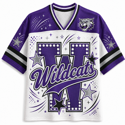 A purple and white short-sleeve athletic jersey with 'Wildcats' lettering, a large 'W' graphic, stars, sparkles, and a wildcat mascot logo on the chest, shown on a plain light background.