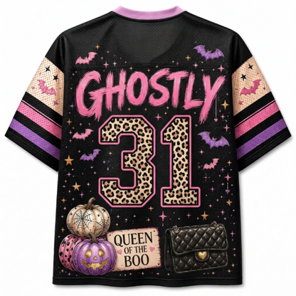 A black short-sleeve mesh jersey-style shirt shown from the back, featuring a Halloween-themed graphic print with the word 'GHOSTLY' in pink, the number '31' in leopard print, bats, pumpkins, stars, and a quilted purse illustration. The sleeves have pink, purple, and beige striped patterns.